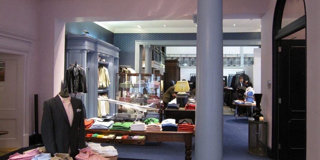 Interior of a tailor shop with displays of tailored clothing and finished garments