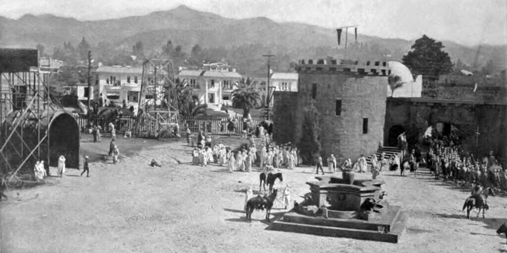 Studio lot production set with period architecture and costumed figures